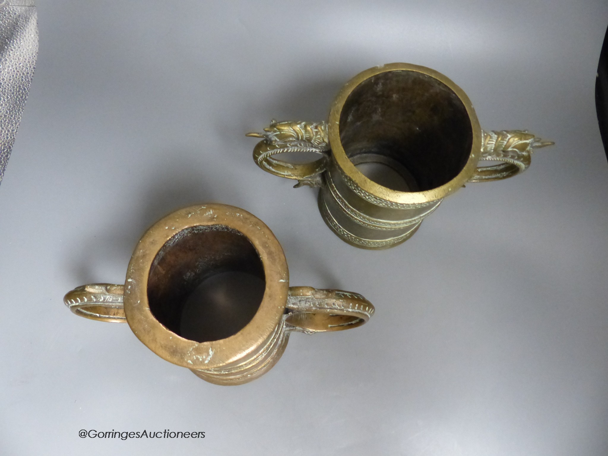 Two Burmese twin handled rice pounders, height 16cm